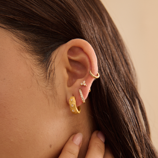 Murkani | 
Cosmic Love Huggie With White Topaz | 18KT Yellow Gold Plate