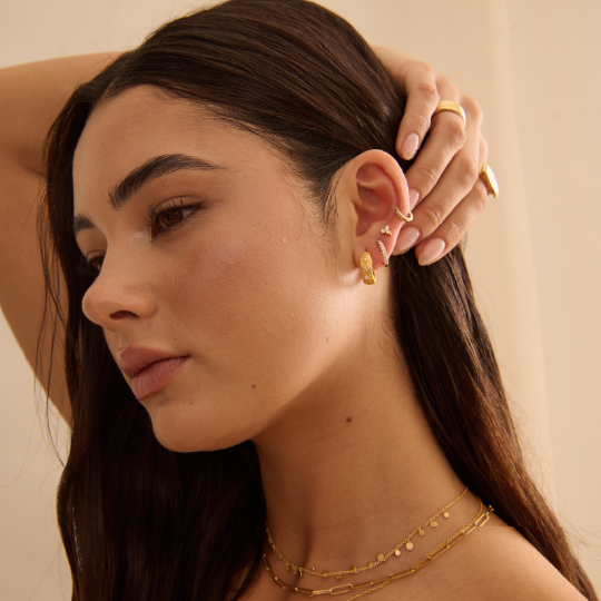 Murkani | 
Cosmic Love Huggie With White Topaz | 18KT Yellow Gold Plate